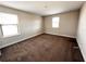 Spacious bedroom with carpeted floors and two large windows at 210 Kenny Blvd, Haines City, FL 33844