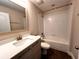 Clean bathroom with tub, toilet and vanity at 210 Kenny Blvd, Haines City, FL 33844
