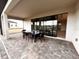 Covered patio with table and chairs, overlooking backyard at 210 Kenny Blvd, Haines City, FL 33844
