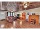 Living room with hardwood floors, a decorative ceiling and wooden furniture at 22134 Obrien Rd, Howey In The Hills, FL 34737