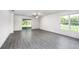 Spacious living room with grey wood-look flooring and sliding glass doors at 16448 Sw 17Th Terrace Rd, Ocala, FL 34473