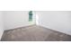 Well-lit bedroom featuring carpeted floors and a view of the backyard at 16448 Sw 17Th Terrace Rd, Ocala, FL 34473