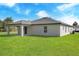 Single-story house with a covered patio and grassy backyard at 16448 Sw 17Th Terrace Rd, Ocala, FL 34473