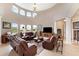 Expansive living room featuring leather furniture, high ceilings, and ample natural light at 13023 Sweet Hill Rd, Polk City, FL 33868