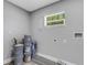 Functional laundry room with vinyl flooring and window at 3419 Lisa Ln, Lakeland, FL 33801