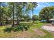 Large backyard with mature trees and grassy lawn at 3419 Lisa Ln, Lakeland, FL 33801