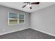 Bright bedroom featuring a window with blinds and ceiling fan at 3419 Lisa Ln, Lakeland, FL 33801