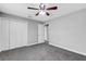 Bedroom with grey carpet, ceiling fan and double door closet at 3419 Lisa Ln, Lakeland, FL 33801