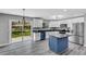 Modern kitchen with white cabinets, blue island, and granite countertops at 3419 Lisa Ln, Lakeland, FL 33801