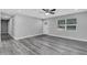 Living room features hardwood floors, ceiling fan, and front door access at 3419 Lisa Ln, Lakeland, FL 33801