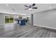 Open living room and kitchen with gray vinyl flooring at 3419 Lisa Ln, Lakeland, FL 33801
