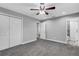 Spacious bedroom with grey carpet, ceiling fan, and double door closet at 3419 Lisa Ln, Lakeland, FL 33801