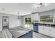 Modern kitchen with white cabinets and a blue island at 3419 Lisa Ln, Lakeland, FL 33801