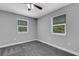 Cozy bedroom with grey carpet, neutral walls, and two windows at 3419 Lisa Ln, Lakeland, FL 33801