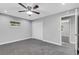 Grey bedroom with carpet, ceiling fan, and double door closet at 3419 Lisa Ln, Lakeland, FL 33801