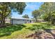 Spacious backyard with a grassy area and mature trees at 3419 Lisa Ln, Lakeland, FL 33801