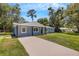 Newly renovated light blue home with a driveway and large yard at 3419 Lisa Ln, Lakeland, FL 33801