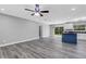 Open living room and kitchen with gray vinyl flooring at 3419 Lisa Ln, Lakeland, FL 33801
