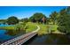 Wooden footbridge over calm water at 7811 Red Grange Blvd, Indian Lake Estates, FL 33855
