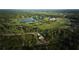 Aerial view showing home's location near golf course at 7811 Red Grange Blvd, Indian Lake Estates, FL 33855