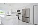 Modern kitchen with white cabinets and stainless steel appliances at 7811 Red Grange Blvd, Indian Lake Estates, FL 33855
