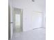 Bright hallway with white walls and tiled floors at 7811 Red Grange Blvd, Indian Lake Estates, FL 33855