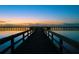 Tranquil view of a long pier at sunset over still water at 7811 Red Grange Blvd, Indian Lake Estates, FL 33855
