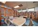 Community room with bookshelves, tables, and a game area at 7811 Red Grange Blvd, Indian Lake Estates, FL 33855
