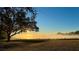 Sunrise over tranquil lake at 7811 Red Grange Blvd, Indian Lake Estates, FL 33855