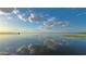 Stunning lake view with a pier and reflections at 7811 Red Grange Blvd, Indian Lake Estates, FL 33855