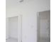 Bedroom with two doors and white walls and flooring at 7811 Red Grange Blvd, Indian Lake Estates, FL 33855
