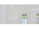 Open concept living room with sliding glass doors at 7811 Red Grange Blvd, Indian Lake Estates, FL 33855