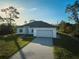 New construction, one-story house, two-car garage, and a large front yard at 7811 Red Grange Blvd, Indian Lake Estates, FL 33855