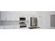 Modern kitchen with stainless steel appliances and white shaker cabinets at 7811 Red Grange Blvd, Indian Lake Estates, FL 33855