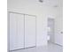 Bedroom with double door closet and access to another room at 7811 Red Grange Blvd, Indian Lake Estates, FL 33855