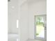 Bright entryway with white walls and tile floors at 7811 Red Grange Blvd, Indian Lake Estates, FL 33855