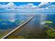 Long wooden pier extending over calm lake water at 7811 Red Grange Blvd, Indian Lake Estates, FL 33855
