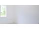 Bright bedroom with one window, white walls, and tile floor at 7811 Red Grange Blvd, Indian Lake Estates, FL 33855