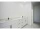 Double vanity bathroom with white cabinets and quartz countertop at 7811 Red Grange Blvd, Indian Lake Estates, FL 33855