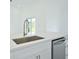 White kitchen with stainless steel sink and dishwasher at 7811 Red Grange Blvd, Indian Lake Estates, FL 33855