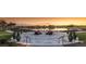 Expansive lakefront patio with seating and beautiful sunset views at 4083 Nw 44Th Cir, Ocala, FL 34482