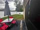 Backyard patio with table and chairs, small lawn and fence at 319 Hibiscus Dr, Kissimmee, FL 34759