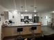 Open concept kitchen with island and breakfast bar at 319 Hibiscus Dr, Kissimmee, FL 34759