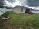 Backyard view showcasing house, patio and grassy area at 319 Hibiscus Dr, Kissimmee, FL 34759