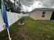 Side yard view showing small tree and grassy area at 319 Hibiscus Dr, Kissimmee, FL 34759