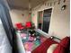 Bright screened porch featuring comfortable seating and string lights at 319 Hibiscus Dr, Kissimmee, FL 34759
