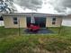 Backyard with patio, lighting, and small lawn area at 319 Hibiscus Dr, Kissimmee, FL 34759
