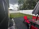 Small backyard with patio furniture, grassy area and white fence at 319 Hibiscus Dr, Kissimmee, FL 34759