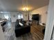 Spacious living room with large TV and comfortable seating at 319 Hibiscus Dr, Kissimmee, FL 34759