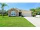 Charming one-story house with stone accents and a grassy yard at 31817 Sunpark Cir, Leesburg, FL 34748